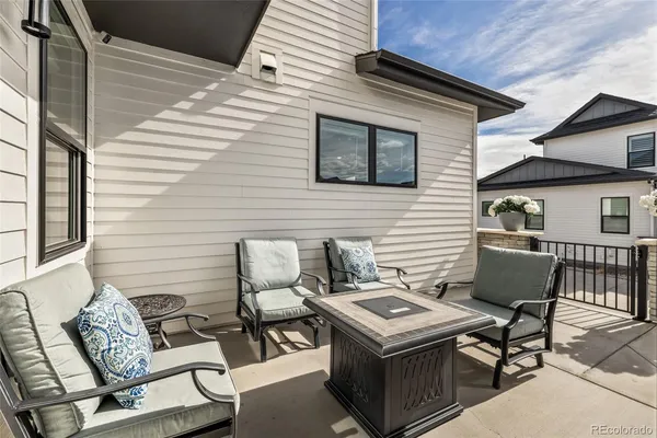 a balcony with a table and chairs
