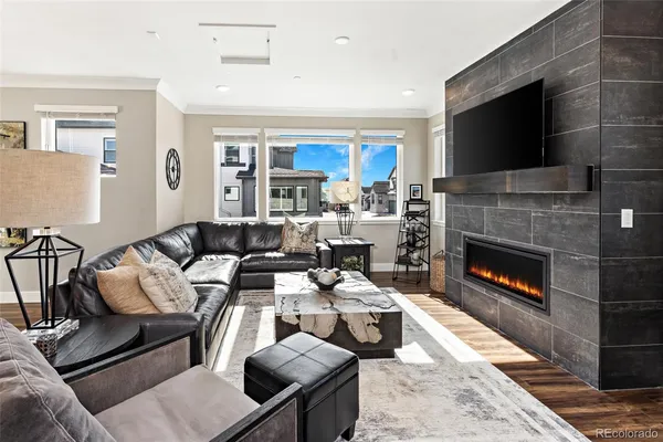 a living room with furniture a flat screen tv and a fireplace