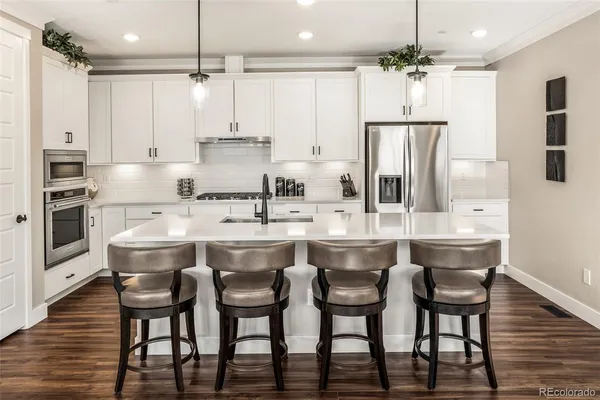 a large kitchen with a table and chairs