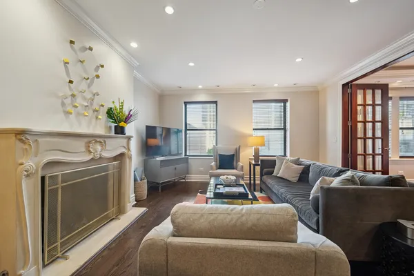 a living room with furniture a window and a fireplace