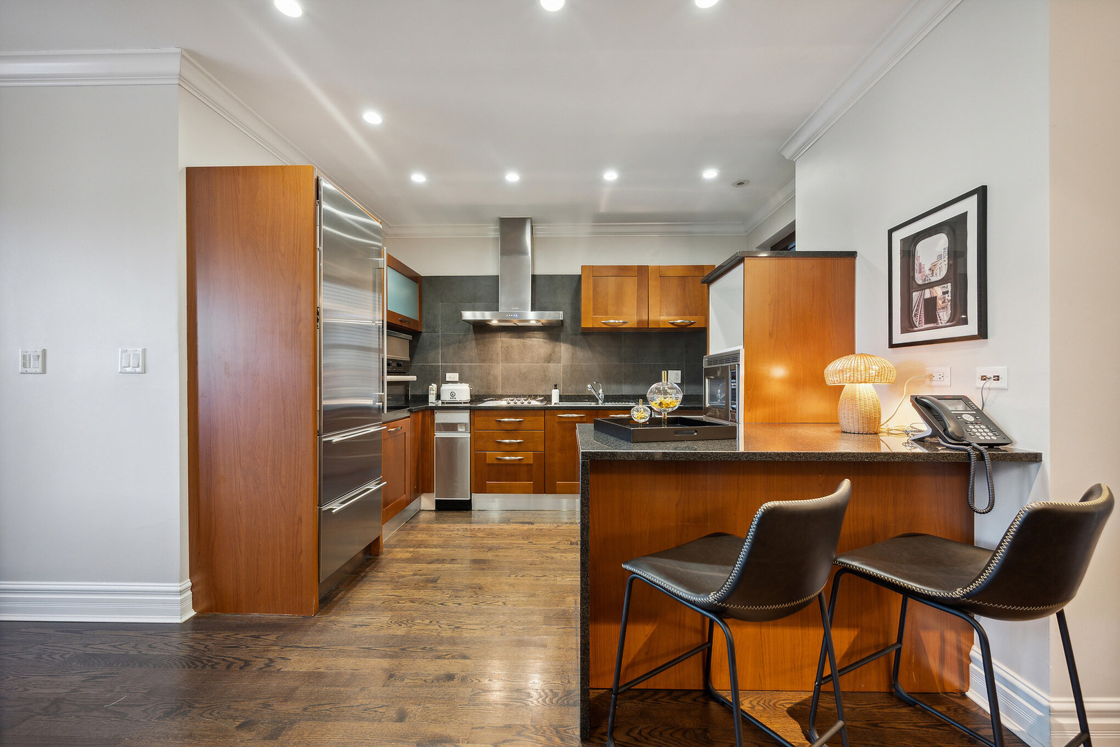 70 East Walton Street, Unit 404 Chicago, IL 60611 - Photo 5 of 14 a kitchen with granite countertop counter space a sink appliances and cabinets
