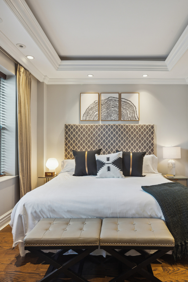 70 East Walton Street, Unit 404 Chicago, IL 60611 - Photo 9 of 14 a bedroom with a bed and wooden floor