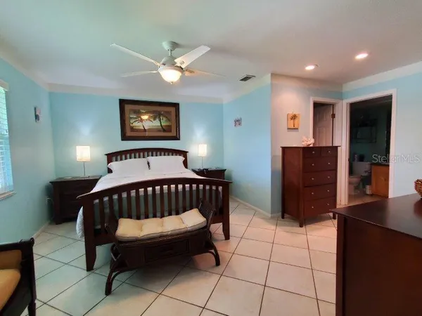 a bedroom with a bed and a view of bathroom