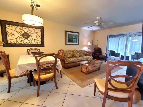 a living room with furniture a flat screen tv and a window