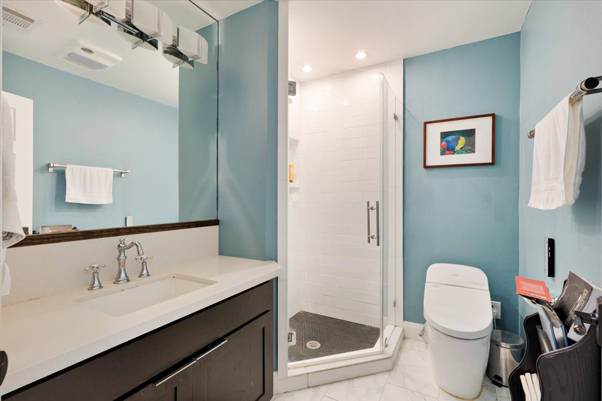 201 Vanderpool Lane, Unit 130 Houston, TX 77024 - Photo 11 of 23 a bathroom with a sink vanity mirror and toilet