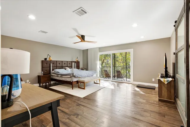 a living room with furniture a window and a flat screen tv