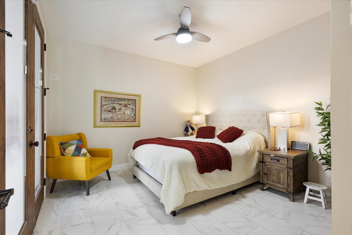 201 Vanderpool Lane, Unit 130 Houston, TX 77024 - Photo 9 of 23 a spacious bedroom with a bed a couch and a chandelier