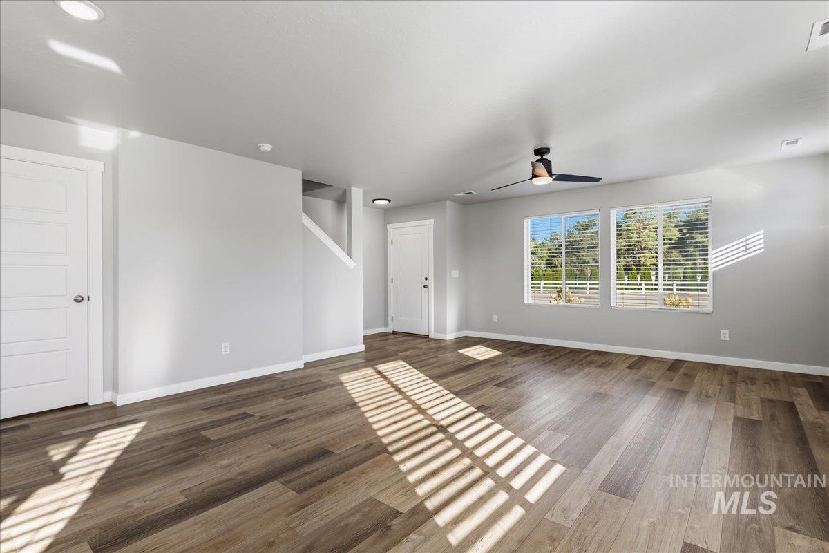 12509 West Victory Road Boise, ID 83709 - Photo 7 of 23 Wood-finish flooring, recessed lighting, and a contemporary ceiling fan