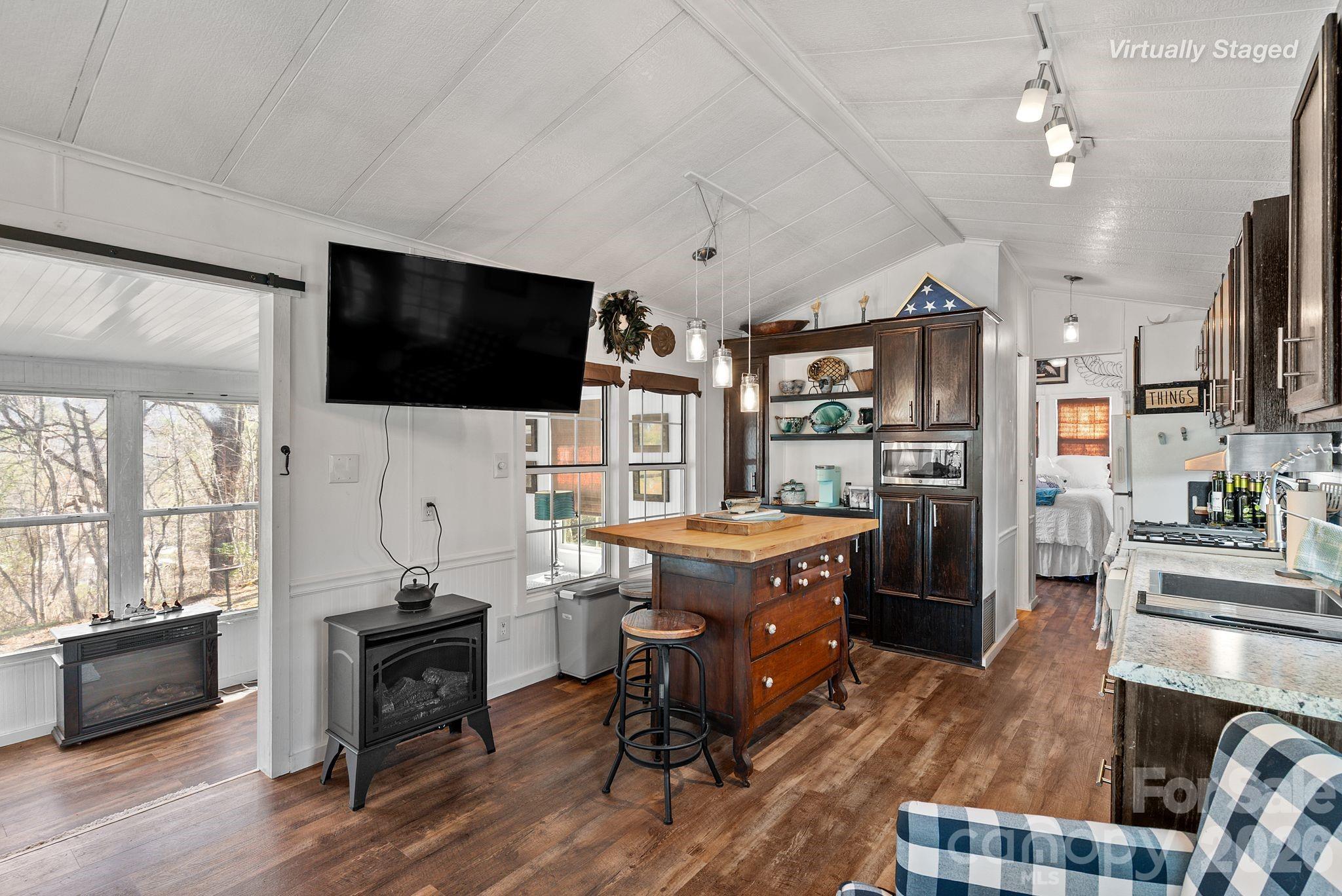 54 South Kimiko Lane Balsam Grove, NC 28708 - Photo 20 of 46 a living room with stainless steel appliances kitchen island granite countertop furniture and a flat screen tv