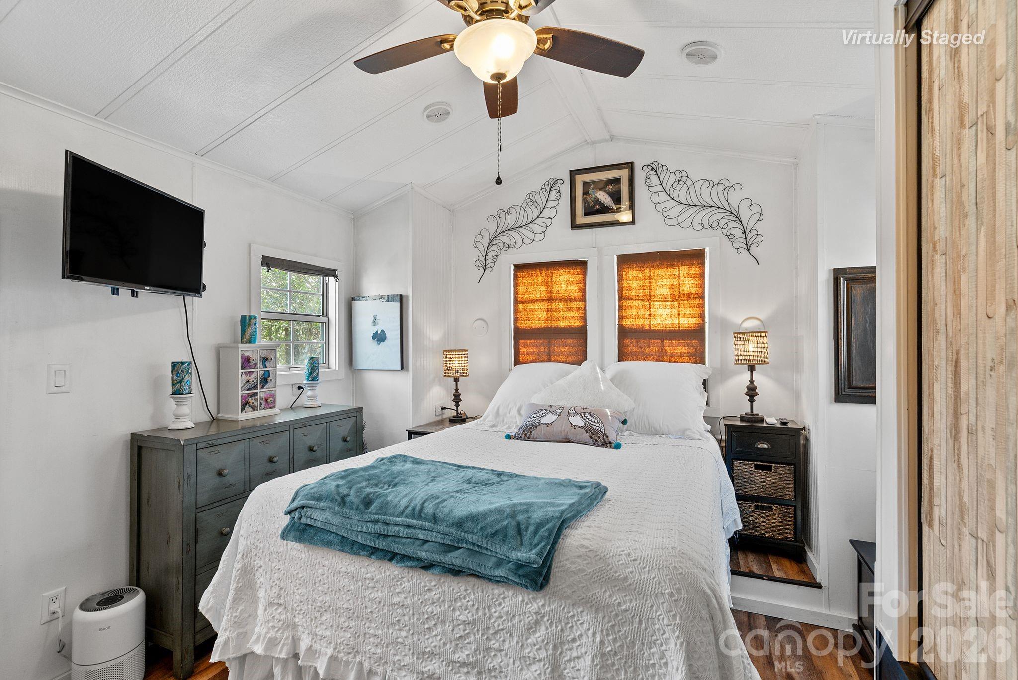 54 South Kimiko Lane Balsam Grove, NC 28708 - Photo 22 of 46 a bedroom with a bed and a flat screen tv