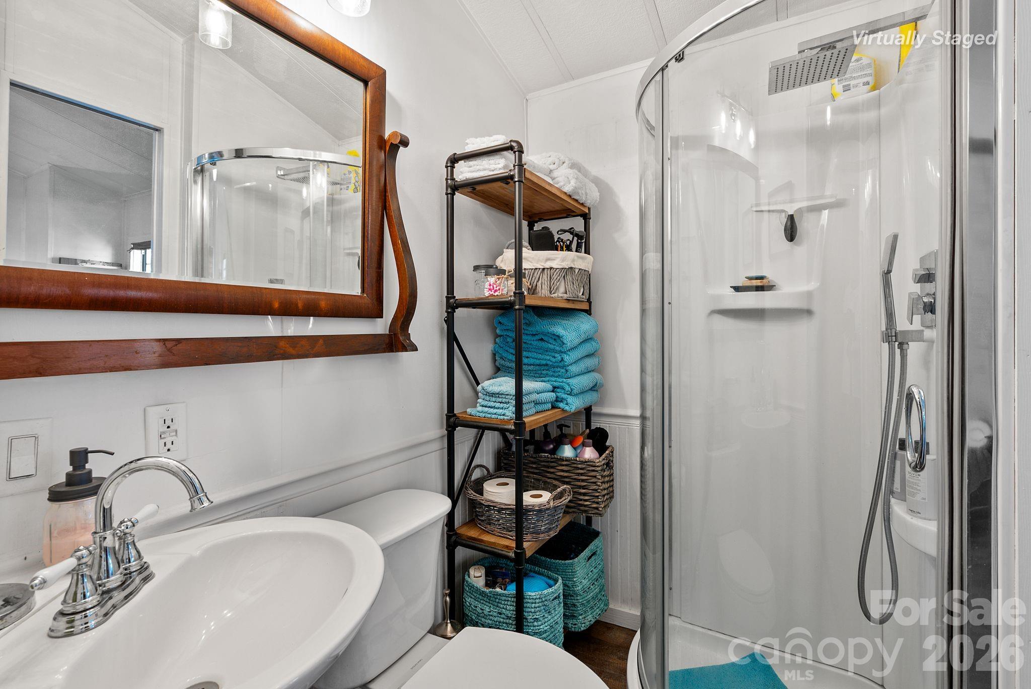 54 South Kimiko Lane Balsam Grove, NC 28708 - Photo 24 of 46 a bathroom with a sink vanity mirror and toilet