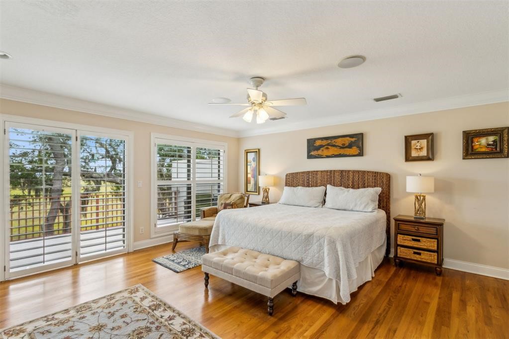 3119 Sea Marsh Road Fernandina Beach, FL 32034 - Photo 6 of 41 a bedroom with a large bed and a chandelier