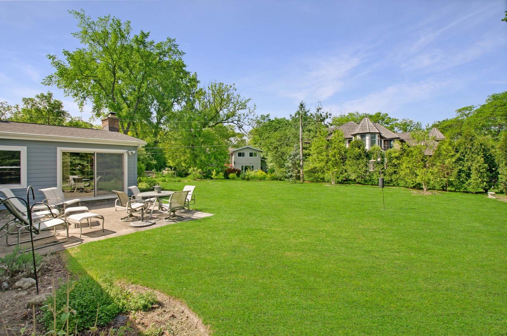 1246 Ridge Road Highland Park, IL 60035 - Photo 19 of 22 a view of a house with backyard sitting area and garden
