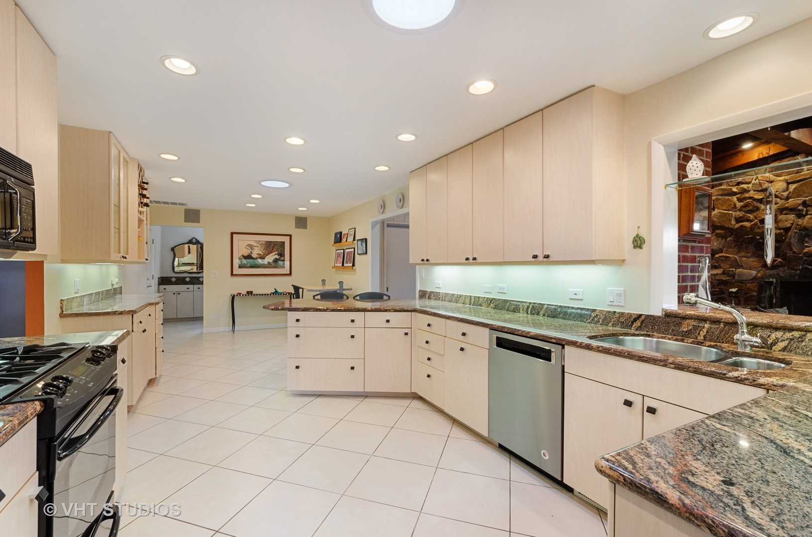 1246 Ridge Road Highland Park, IL 60035 - Photo 7 of 22 a large kitchen with granite countertop a stove top oven a sink a dining table and chairs