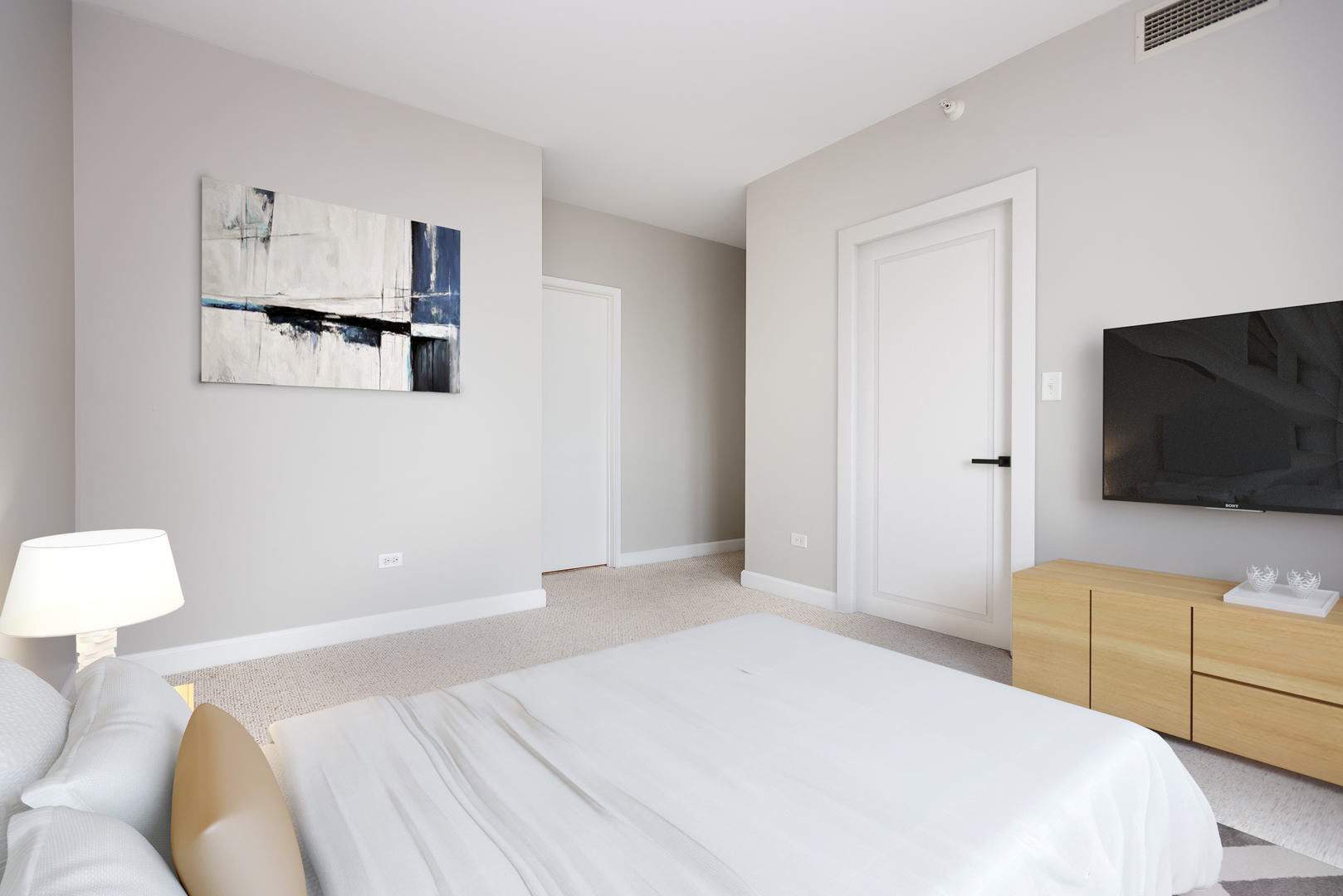 1101 South State Street, Unit 1804 Chicago, IL 60605 - Photo 12 of 29 a bedroom with a bed and a flat screen tv