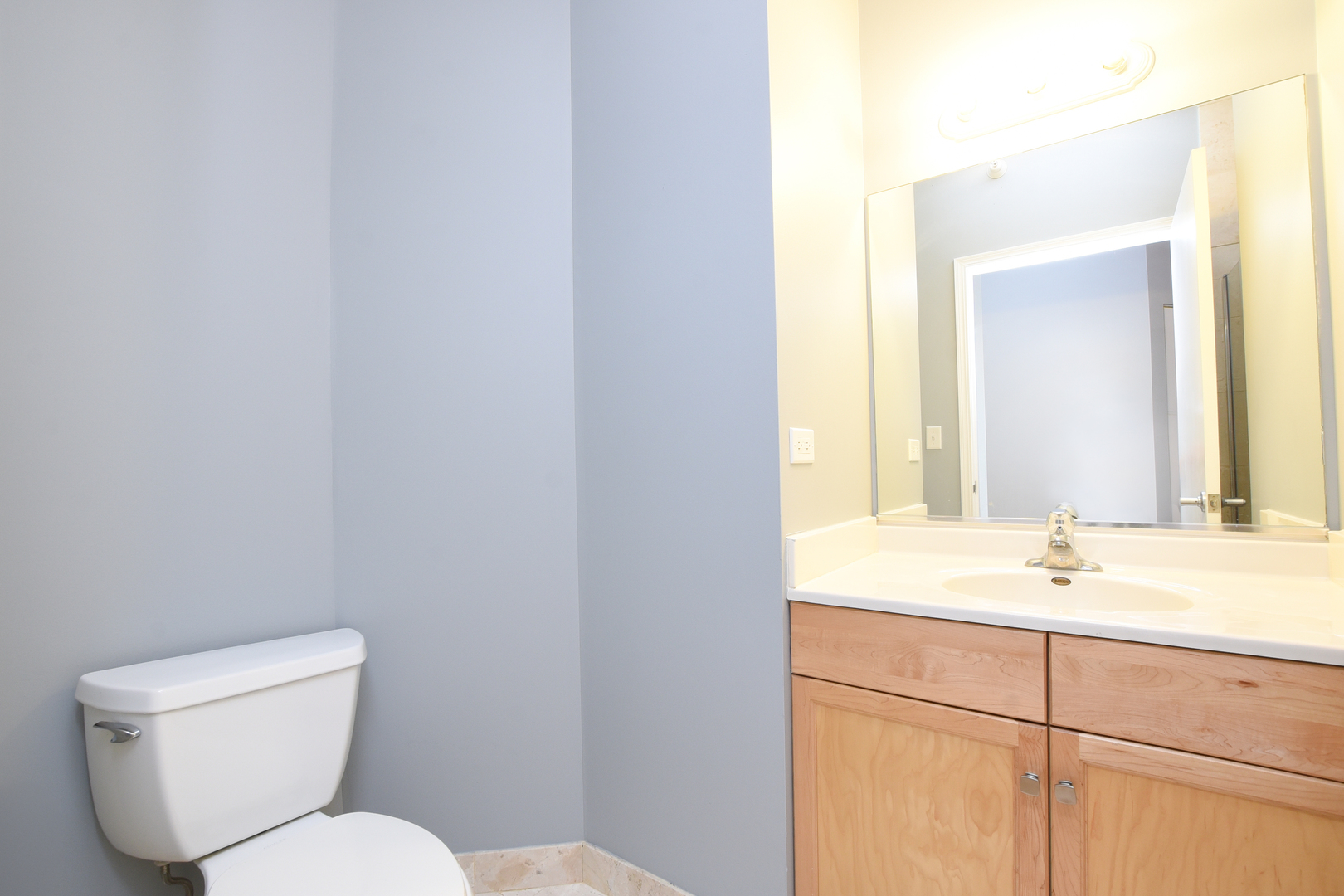 1101 South State Street, Unit 1804 Chicago, IL 60605 - Photo 19 of 29 a bathroom with a toilet sink and mirror