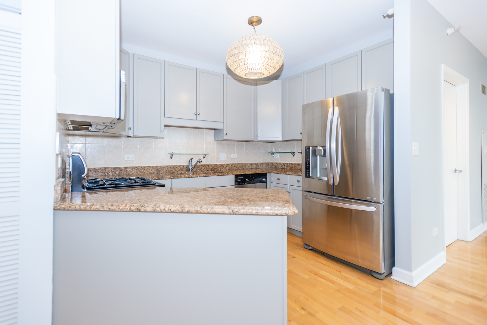 1101 South State Street, Unit 1804 Chicago, IL 60605 - Photo 8 of 29 a kitchen with stainless steel appliances granite countertop a refrigerator and a stove