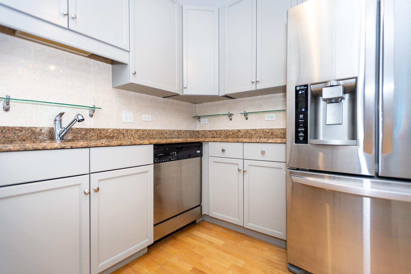 1101 South State Street, Unit 1804 Chicago, IL 60605 - Photo 9 of 29 a kitchen with granite countertop cabinets stainless steel appliances and a counter space