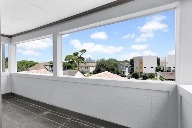 a bathroom with a window sink and mirror