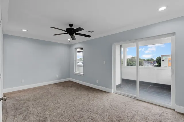 a view of a livingroom with a ceiling fan and window