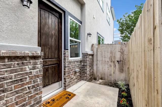 a backyard of a house with potted plants