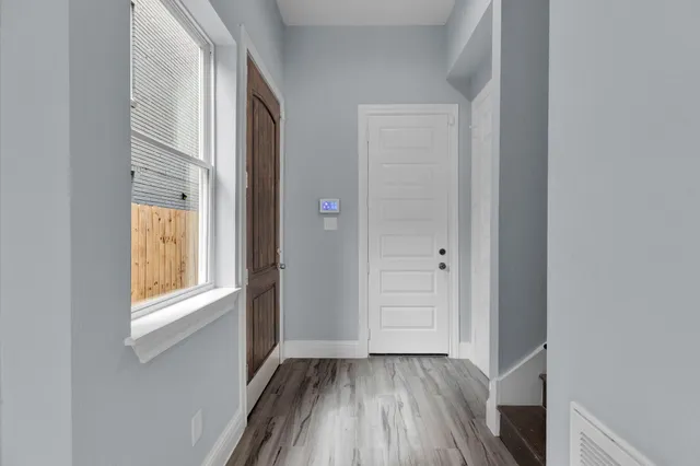 a view of an empty room with closet and a window