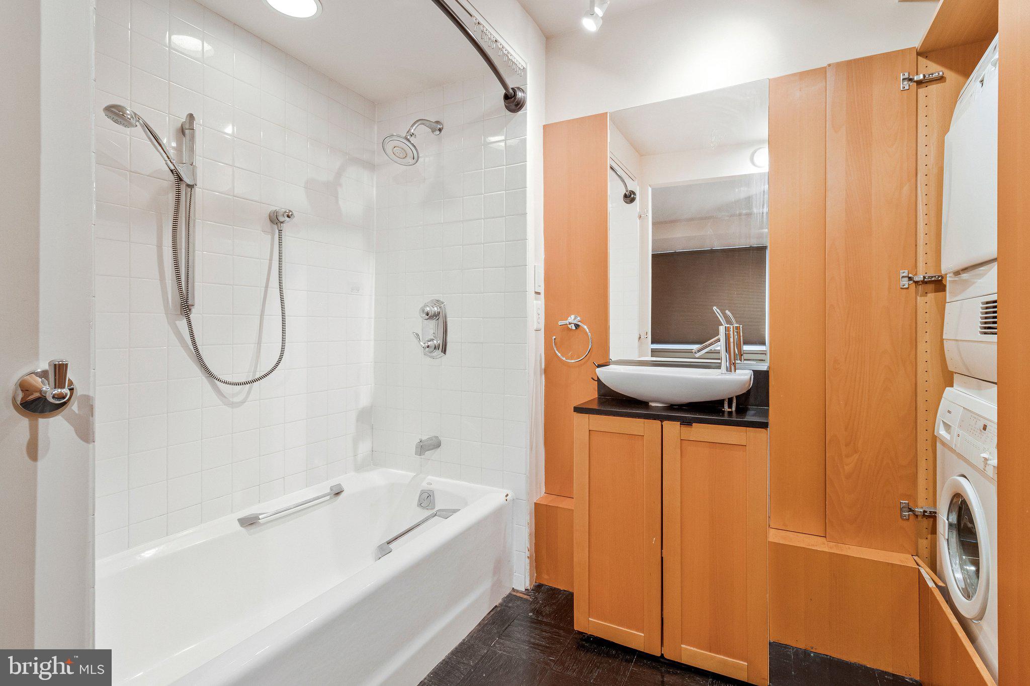 510 N Street Southwest, Unit N622 Washington, DC 20024 - Photo 15 of 29 a bathroom with a shower a mirror and a sink
