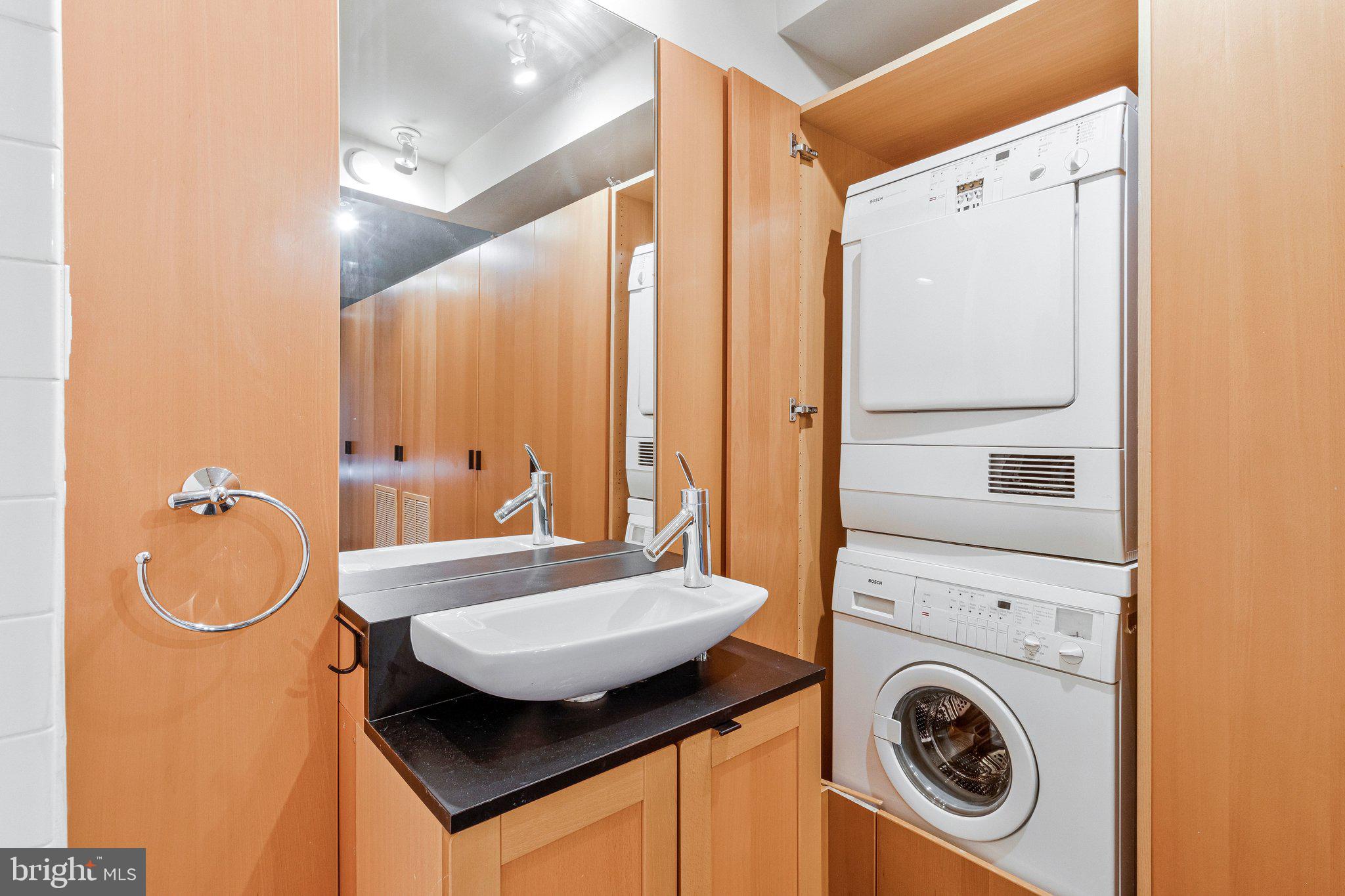 510 N Street Southwest, Unit N622 Washington, DC 20024 - Photo 17 of 29 a bathroom with a sink a toilet and a mirror