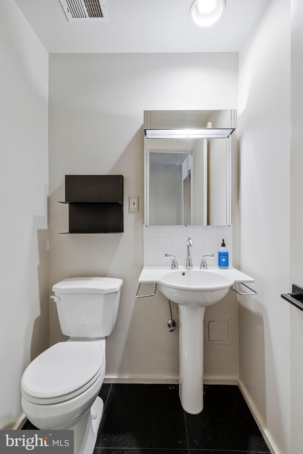 510 N Street Southwest, Unit N622 Washington, DC 20024 - Photo 19 of 29 a bathroom with a toilet sink and mirror