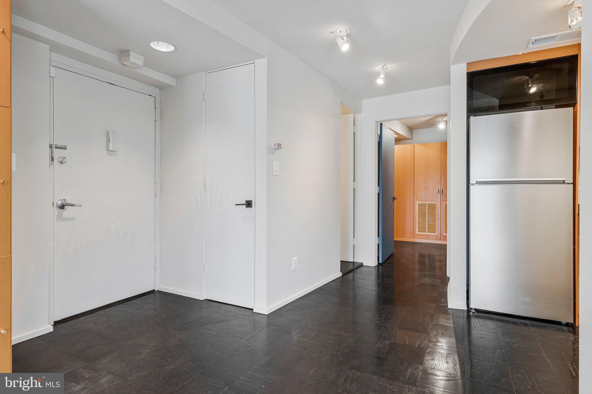 510 N Street Southwest, Unit N622 Washington, DC 20024 - Photo 2 of 29 a view of an empty room with wooden floor and a refrigerator
