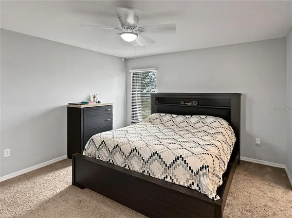 a bedroom with a bed and window