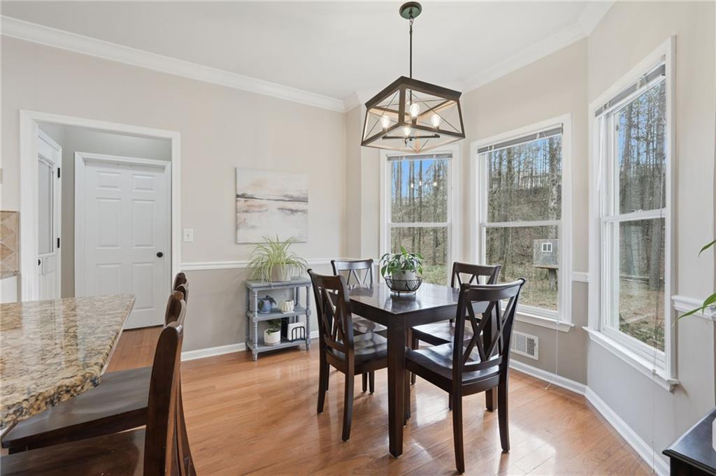 60 Gilbert Circle Northeast Suwanee, GA 30024 - Photo 12 of 47 a view of a dining room with furniture window and wooden floor