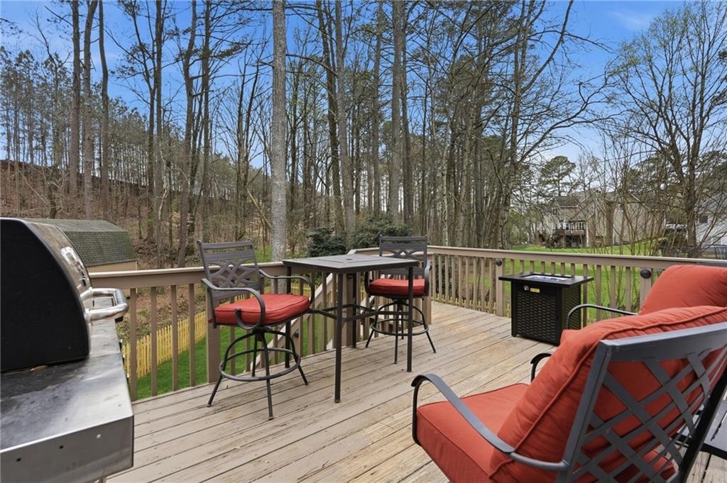60 Gilbert Circle Northeast Suwanee, GA 30024 - Photo 14 of 47 a view of deck with seating space and trees