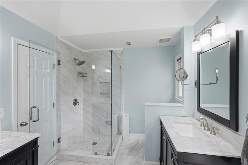 60 Gilbert Circle Northeast Suwanee, GA 30024 - Photo 18 of 47 a bathroom with a sink a toilet and shower