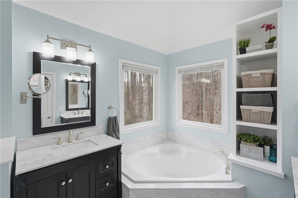 60 Gilbert Circle Northeast Suwanee, GA 30024 - Photo 19 of 47 a bathroom with a tub sink and mirror