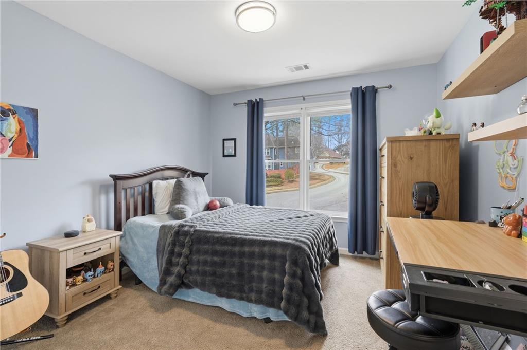 60 Gilbert Circle Northeast Suwanee, GA 30024 - Photo 20 of 47 a bedroom with a bed and wooden floor
