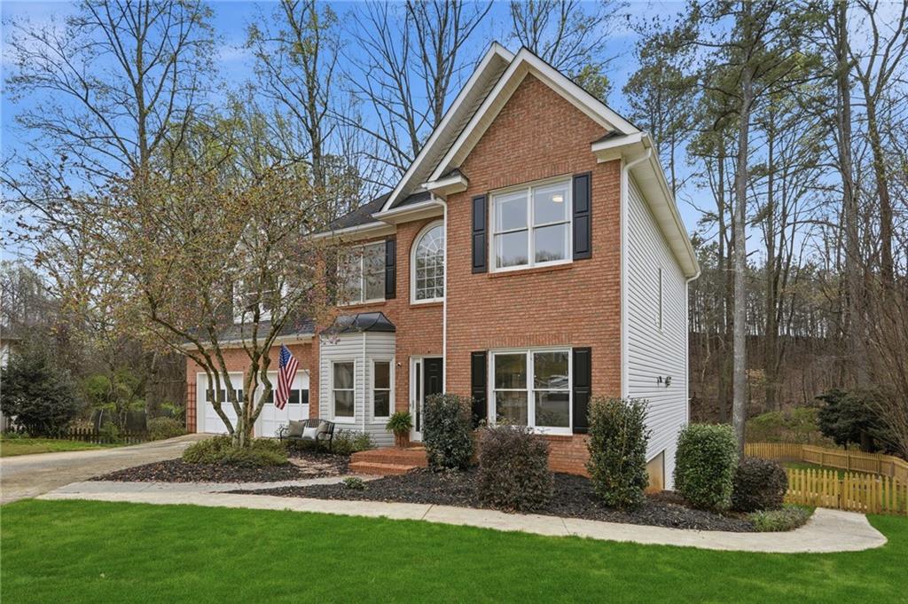 60 Gilbert Circle Northeast Suwanee, GA 30024 - Photo 2 of 47 a front view of a house with garden