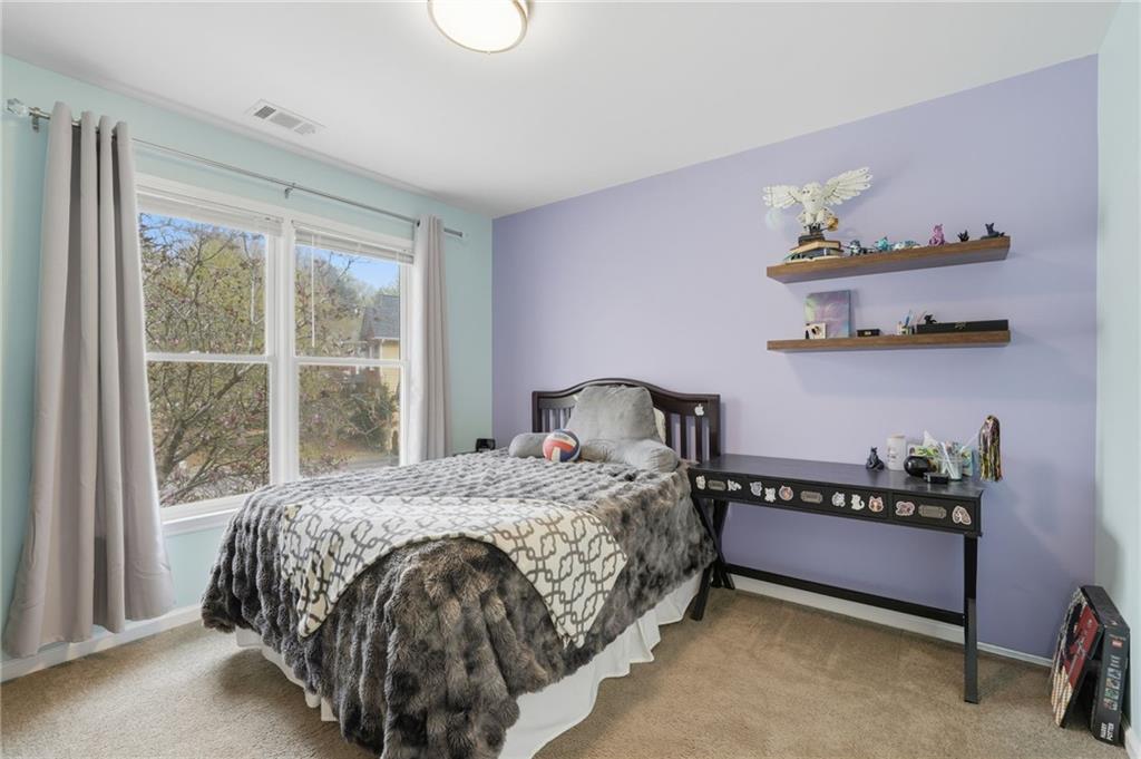60 Gilbert Circle Northeast Suwanee, GA 30024 - Photo 21 of 47 a bedroom with a bed and window