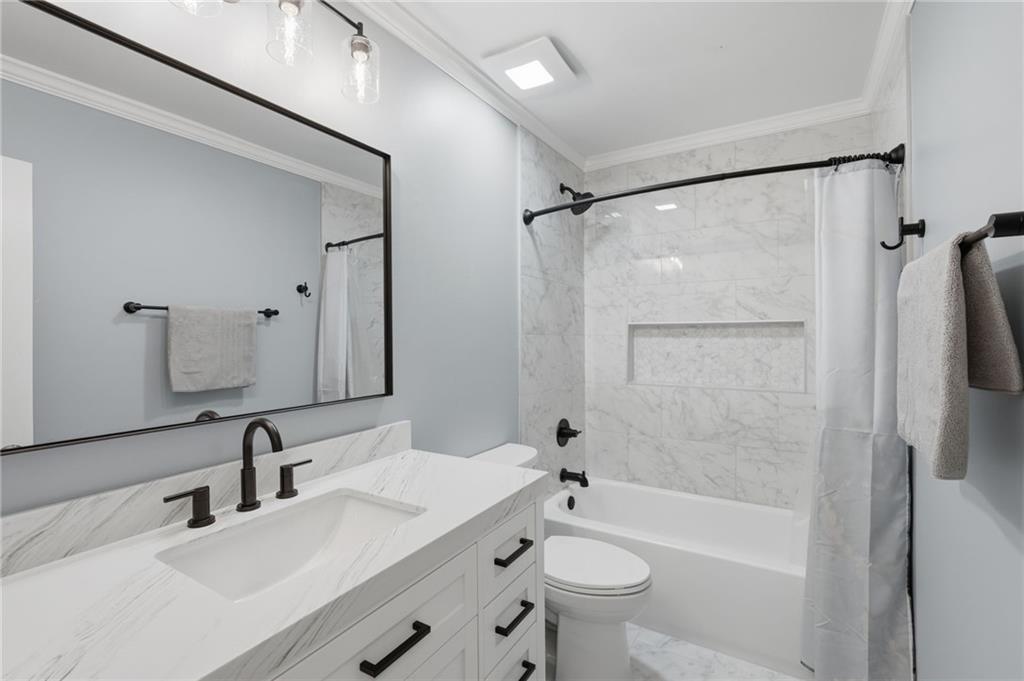 60 Gilbert Circle Northeast Suwanee, GA 30024 - Photo 23 of 47 a bathroom with a sink a toilet and shower