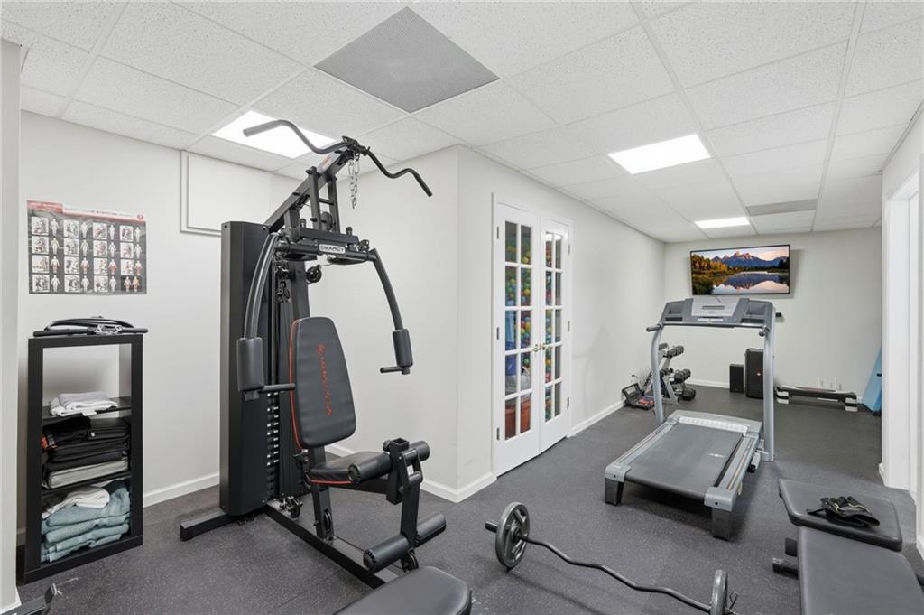 60 Gilbert Circle Northeast Suwanee, GA 30024 - Photo 27 of 47 a room with gym equipment and windows