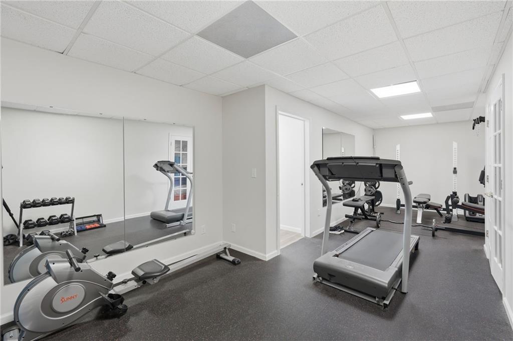 60 Gilbert Circle Northeast Suwanee, GA 30024 - Photo 28 of 47 a room with gym equipment and a table
