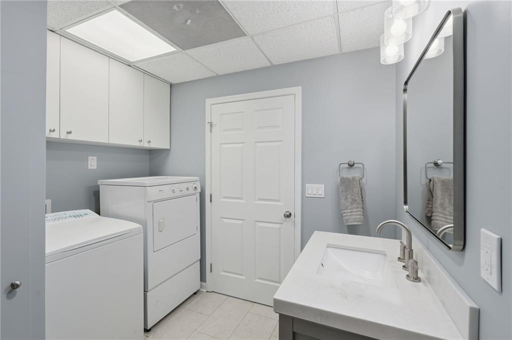 60 Gilbert Circle Northeast Suwanee, GA 30024 - Photo 30 of 47 a bathroom with a sink and a mirror