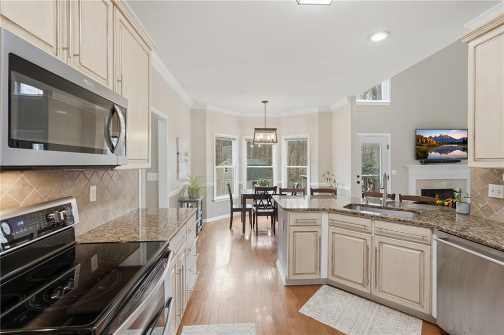 60 Gilbert Circle Northeast Suwanee, GA 30024 - Photo 10 of 47 a kitchen with stainless steel appliances a stove a sink a microwave and cabinets