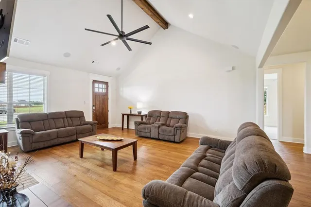 a living room with furniture and a ceiling fan