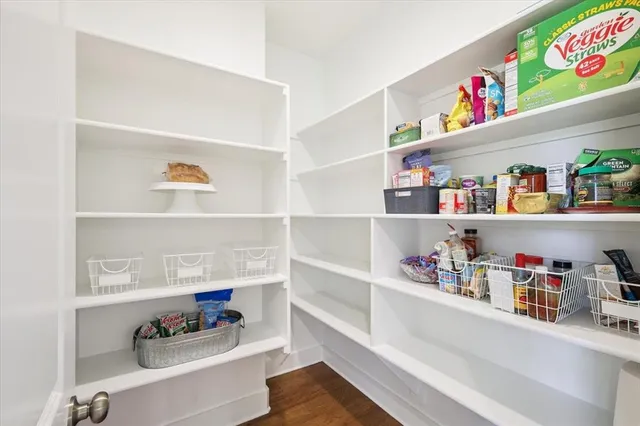a kitchen with stainless steel appliances granite countertop a stove and white cabinets
