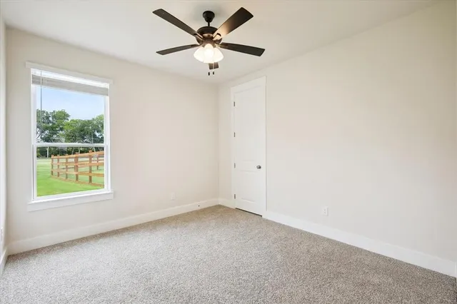 a bedroom with a bed a window and a couch