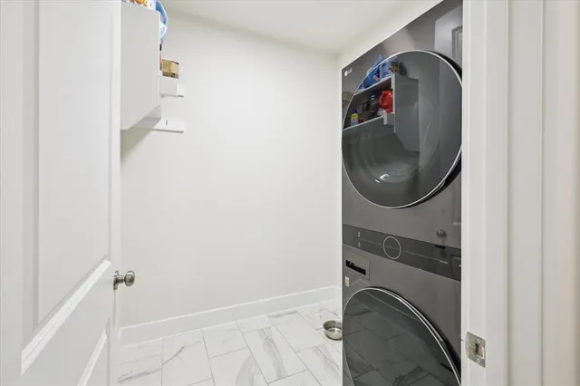 a white bath tub sitting in a bathroom next to a window