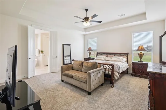 a bathroom with a granite countertop sink a toilet a shower and a mirror