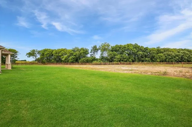 a view of a street with houses and a yard