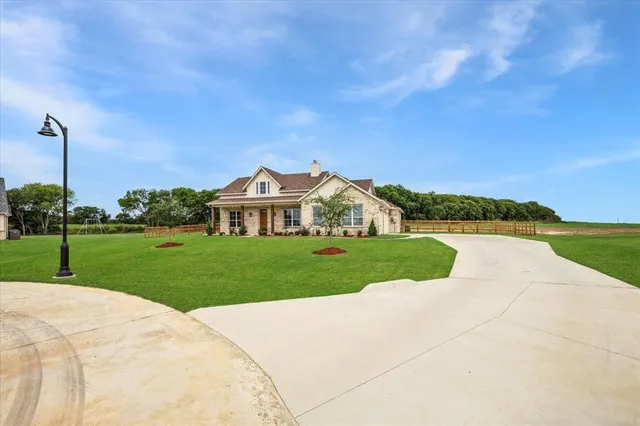 a view of a park with a house in the background